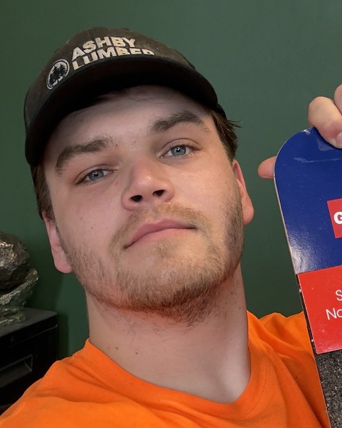 Alex holding a roofing shingle sample